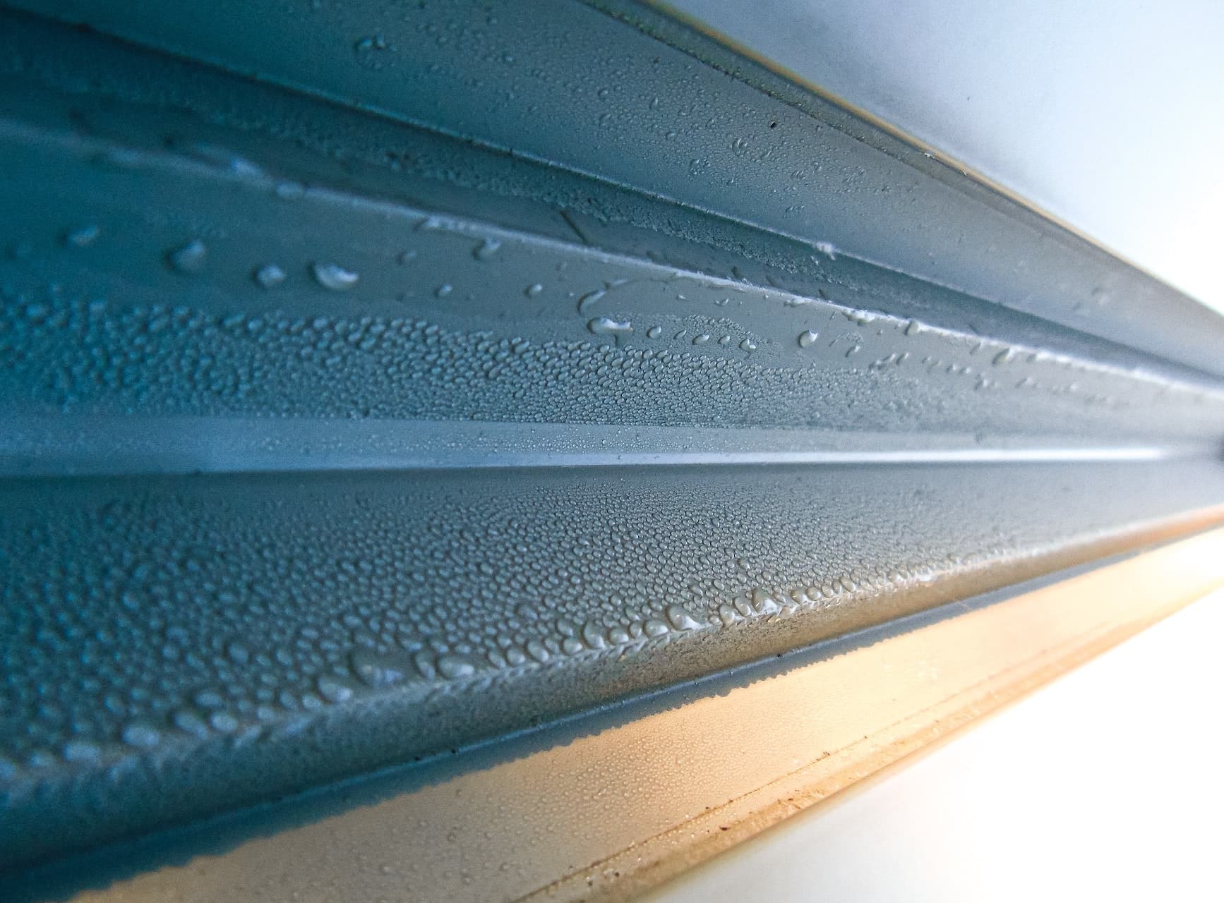 man cleaning the gutters out of a house