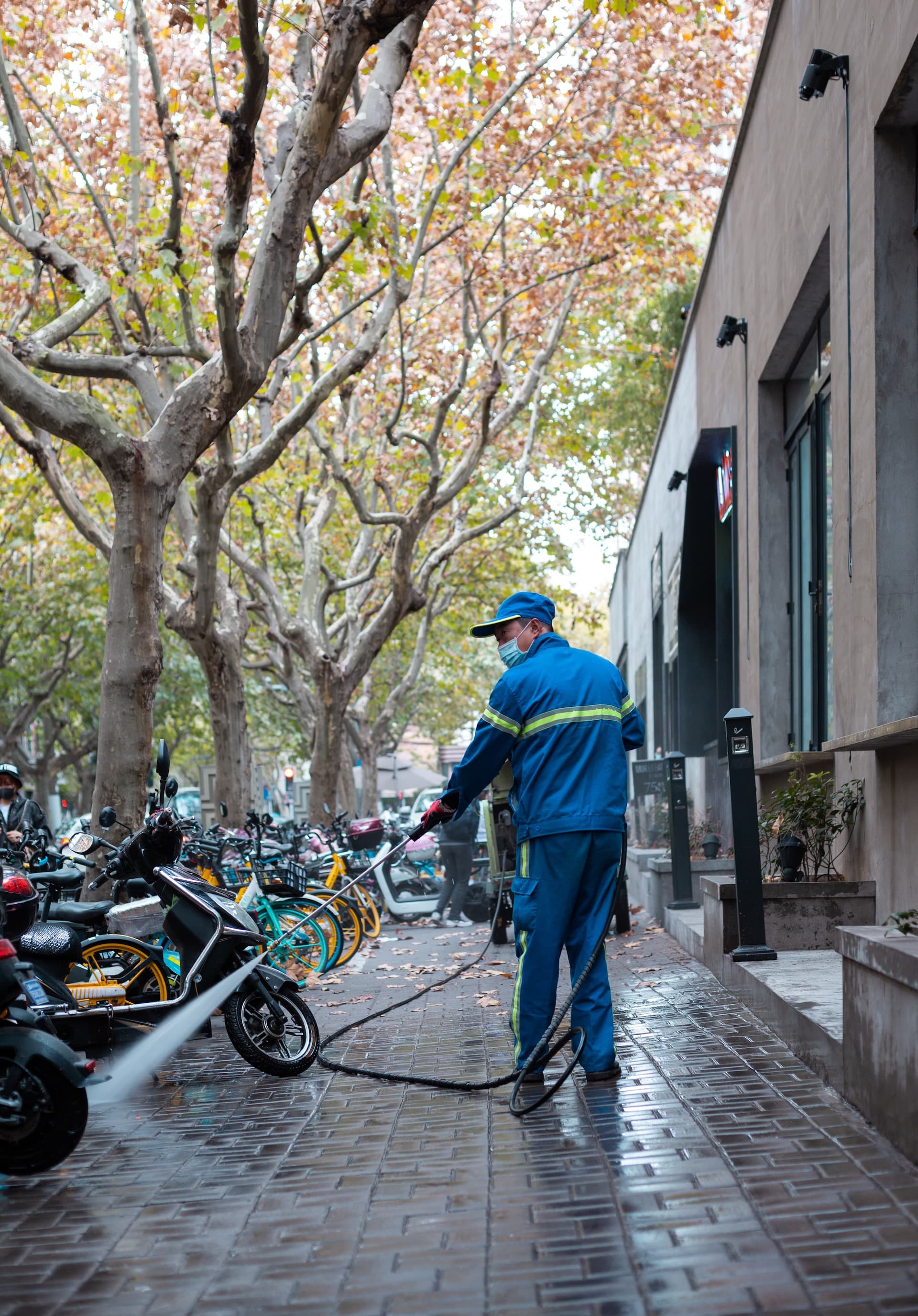service worker power washing the street